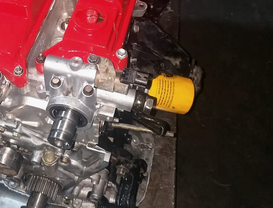 The timing side and oil filter of an engine at the workshop
