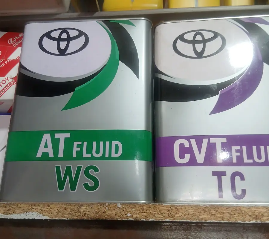Toyota AT fluid and CVT fluid cans on the shop shelf
