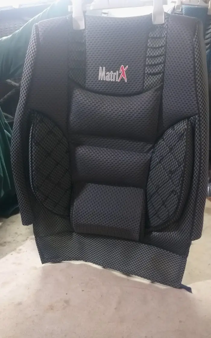 A black quilted car seat cover at the shop