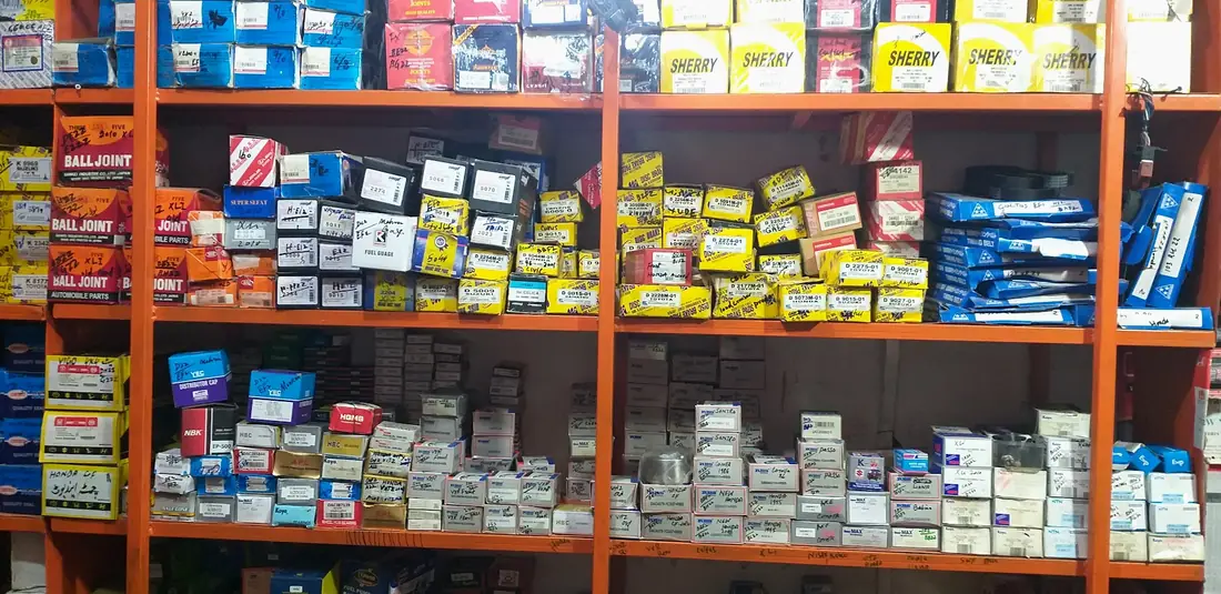Shelves full of car parts inside New Nomi Autos